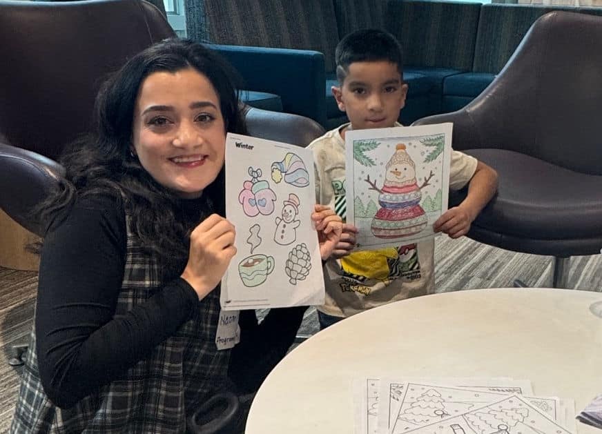 Naomi and Jayden proudly showing off their coloring before his doctor's visit.