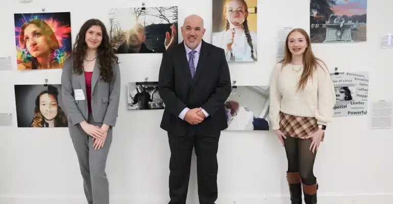 myFace Through My Lens Winners: Sophia Smilenov, Johnathan Hornig, and Eilie Bell standing in front of honored entries.
