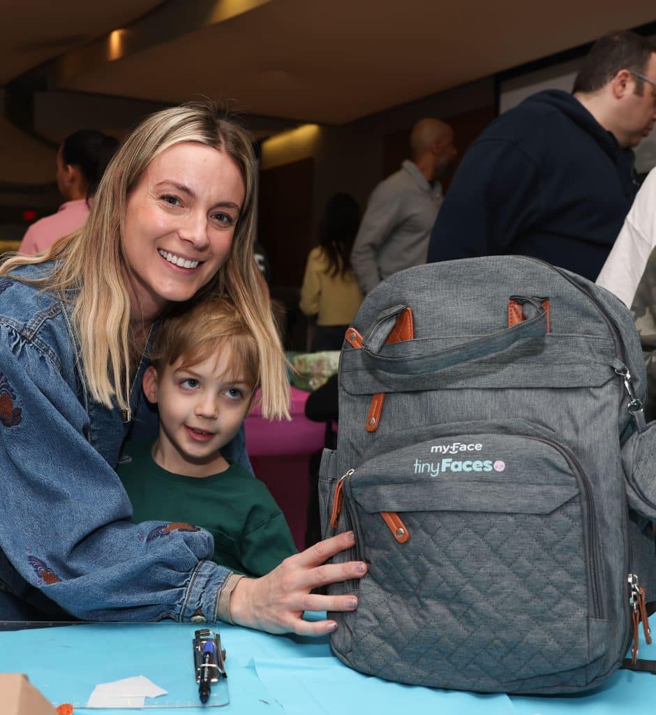 mother and child at an event to pack tinyfaces backpacks